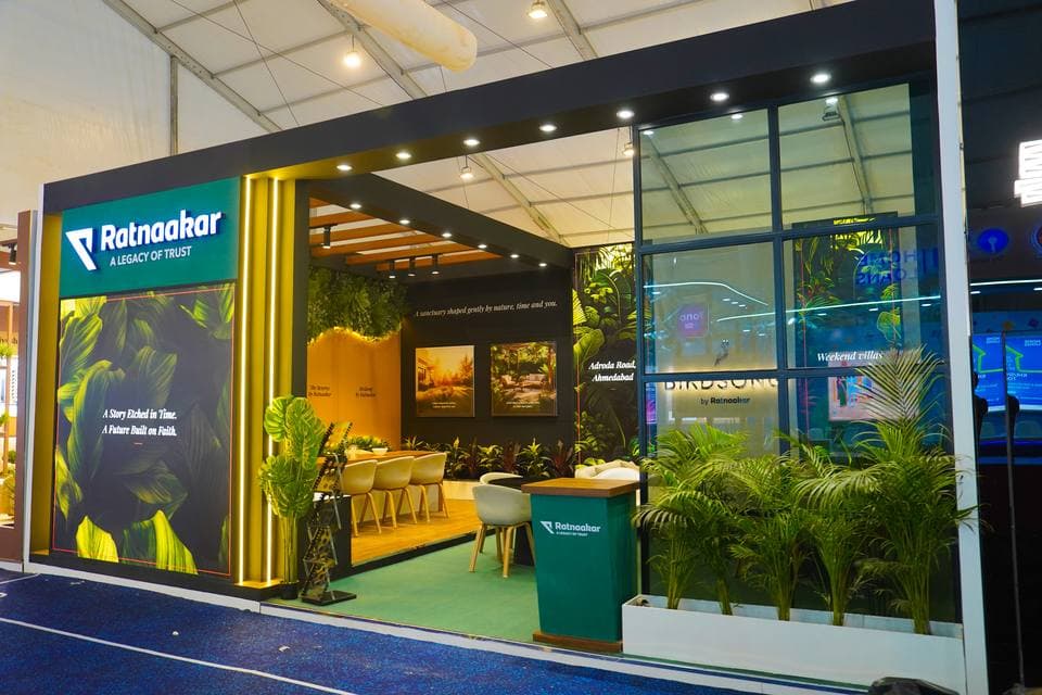 Exhibition booth with edge-lit acrylic brand panels and veneer joinery